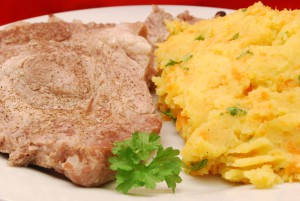 Pochierte Schweinenackenkoteletts mit Kartoffel-Wurzel-Stampf